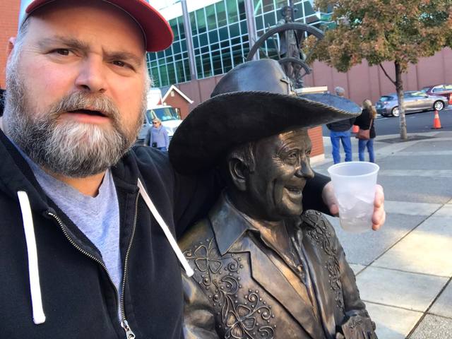 With a cowboy statue holding cup